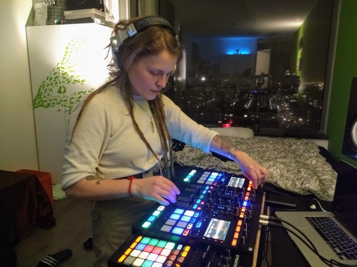 DJ student practising a set with headphones and controller